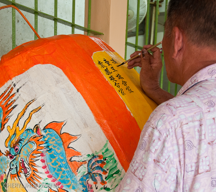 A man writing on a lantern