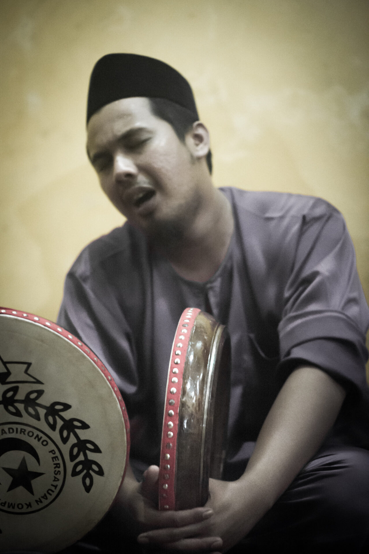 Young man of Persatuan Kompang Kg Madirono group with drum