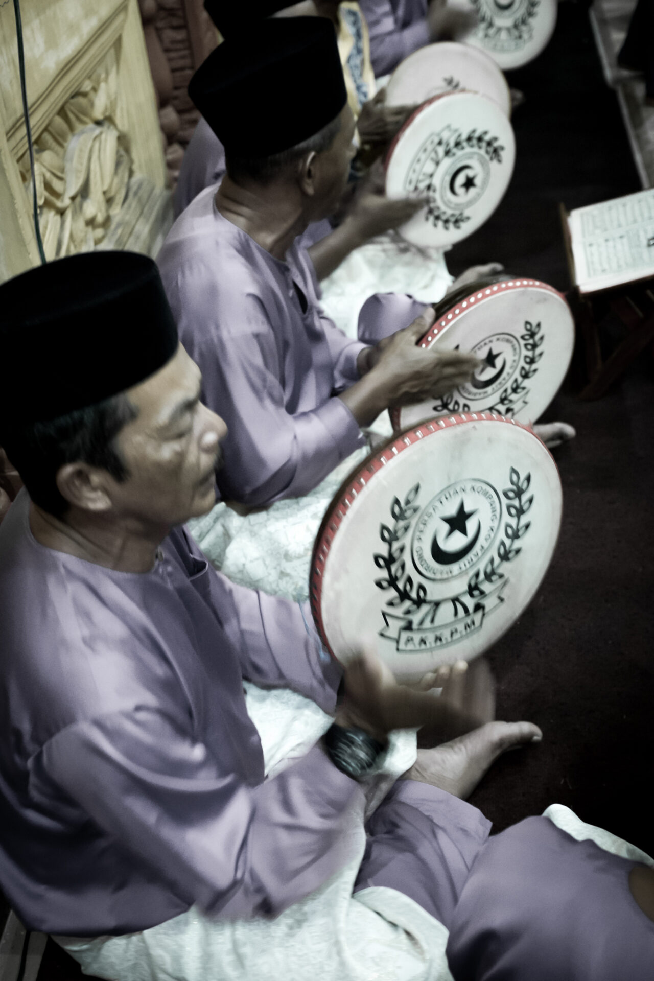 People in similar costumes tapping at Kompang Jidor