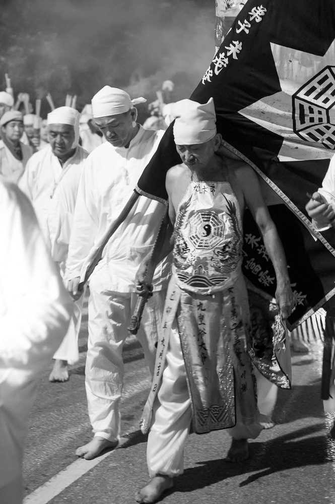 A man carrying a large flag