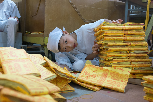 A kid holding stacks