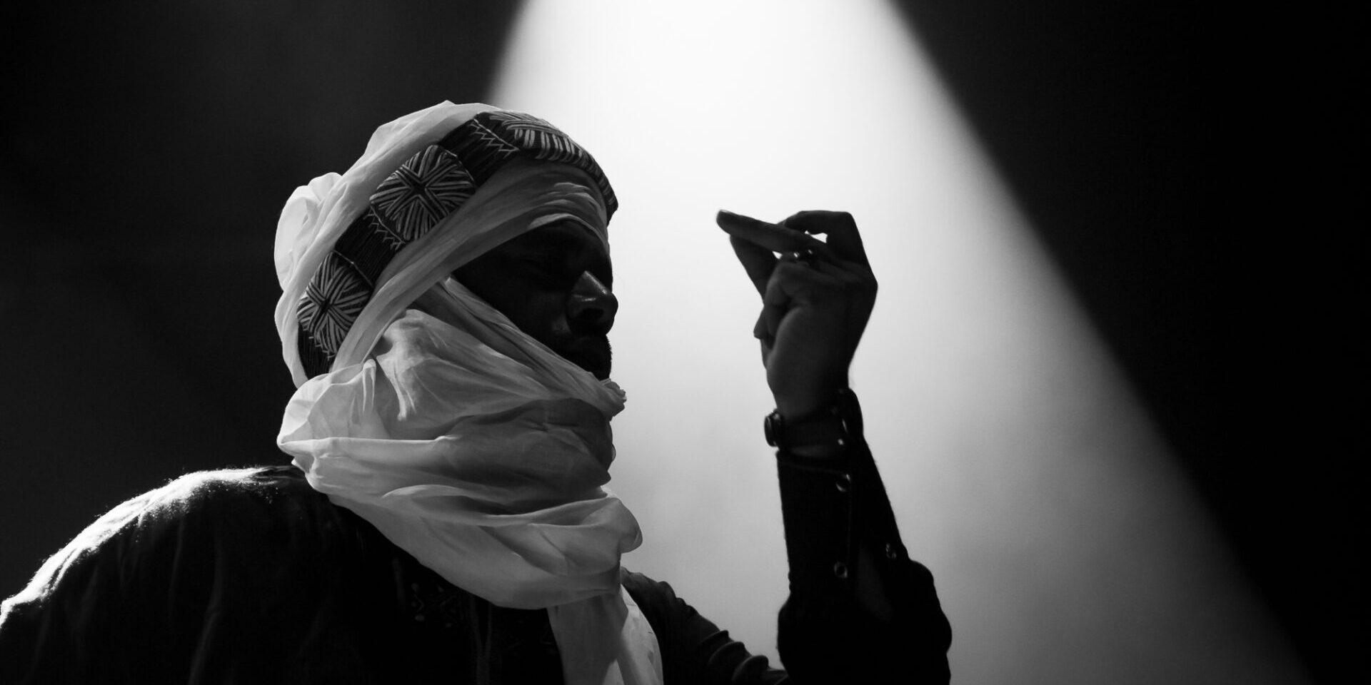 Tinariwen Performing in a Concert, Dancing Through Fire